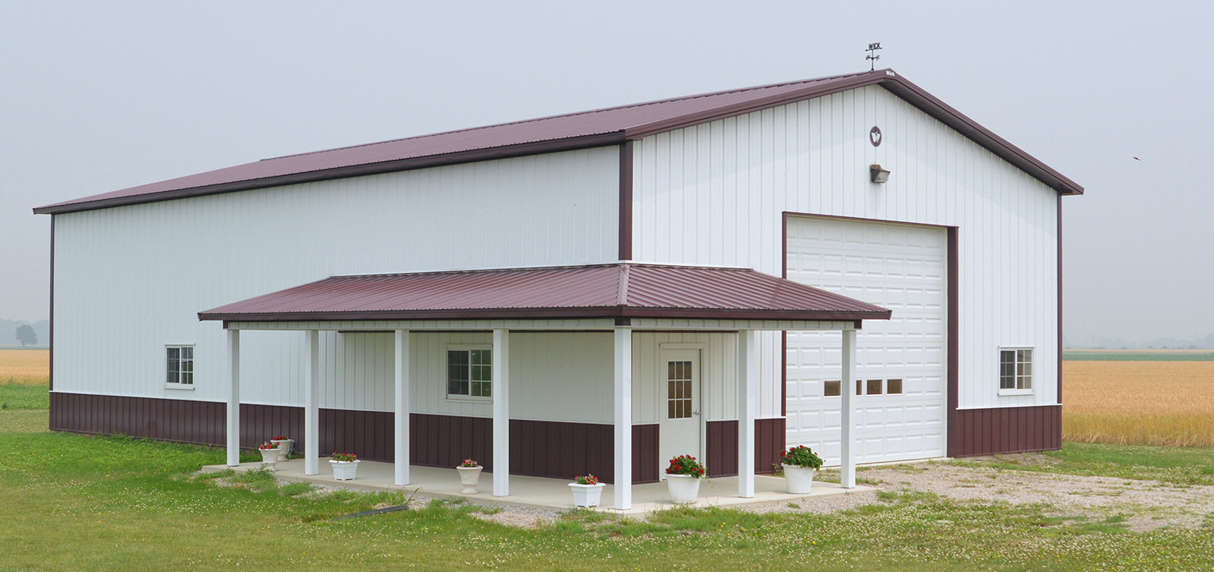 Maroon and white post frame suburban building